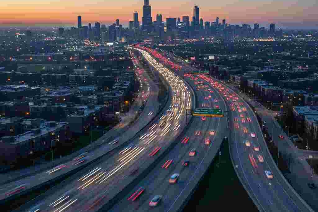 Aerial view of Chicago skyline with luxury car driving on expressway toward O’Hare Airport
